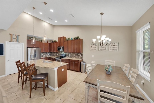 11904 Greenchop Pl, Riverview, FL 33579 - kitchen featuring stainless steel appliances, a sink, a chandelier, tasteful backsplash, and pendant lighting