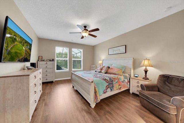 11904 Greenchop Pl, Riverview, FL 33579 - bedroom featuring dark wood finished floors, a textured ceiling, and a ceiling fan