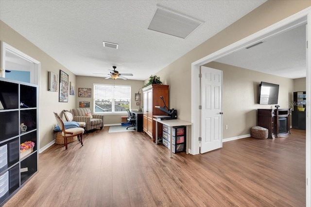 11904 Greenchop Pl, Riverview, FL 33579 - sitting room featuring wood finished floors, baseboards, a ceiling fan, and a textured ceiling