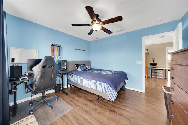 11904 Greenchop Pl, Riverview, FL 33579 - bedroom with wood finished floors, a desk, baseboards, and ceiling fan