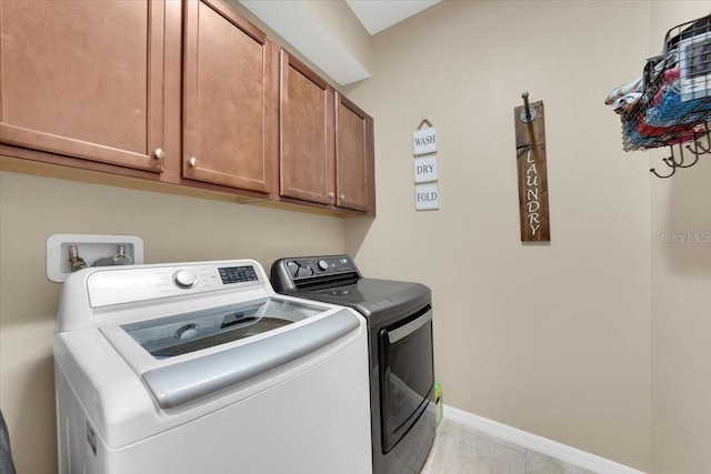 11904 Greenchop Pl, Riverview, FL 33579 - washroom featuring cabinet space, washer and clothes dryer, baseboards, and light tile patterned flooring