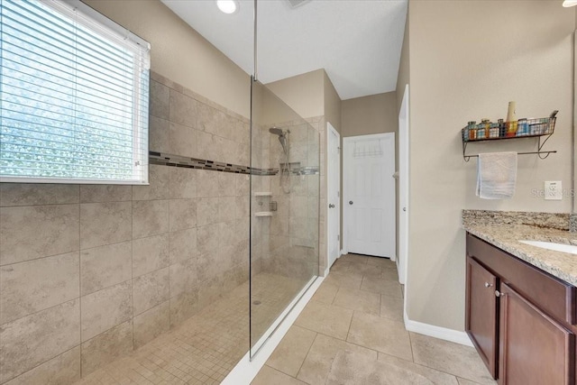 11904 Greenchop Pl, Riverview, FL 33579 - bathroom with a shower stall, vanity, baseboards, and tile patterned flooring