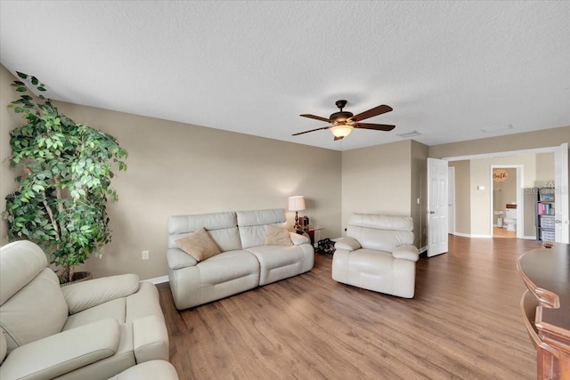 11904 Greenchop Pl, Riverview, FL 33579 - living area featuring wood finished floors, a ceiling fan, baseboards, and a textured ceiling