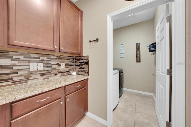 11904 Greenchop Pl, Riverview, FL 33579 - laundry room with washing machine and clothes dryer, light tile patterned floors, and baseboards