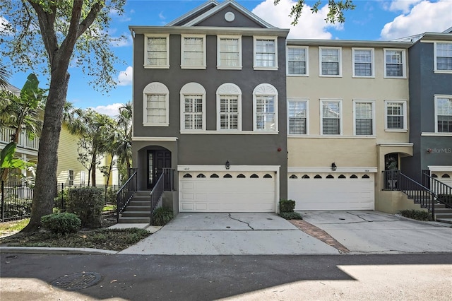 1402 Harbour Walk Rd, Tampa, FL 33602 - view of property with an attached garage, driveway, and stucco siding