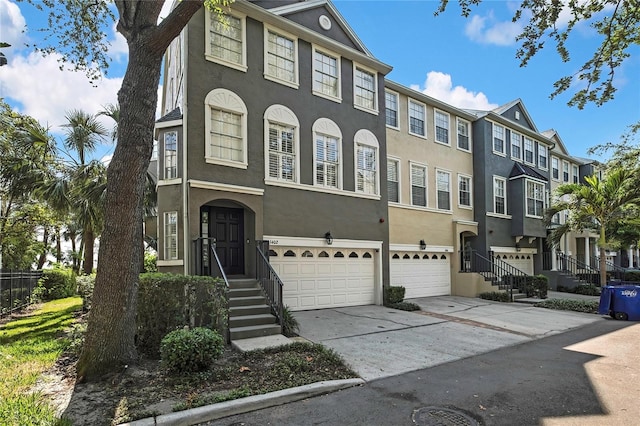 1402 Harbour Walk Rd, Tampa, FL 33602 - view of property with a garage, stucco siding, concrete driveway, and a residential view