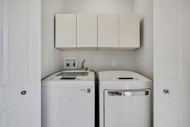 1402 Harbour Walk Rd, Tampa, FL 33602 - washroom featuring washing machine and dryer and cabinet space