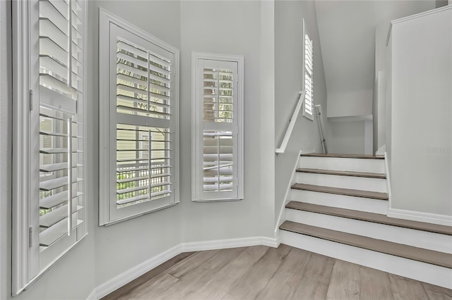 1402 Harbour Walk Rd, Tampa, FL 33602 - staircase featuring plenty of natural light, baseboards, and wood finished floors