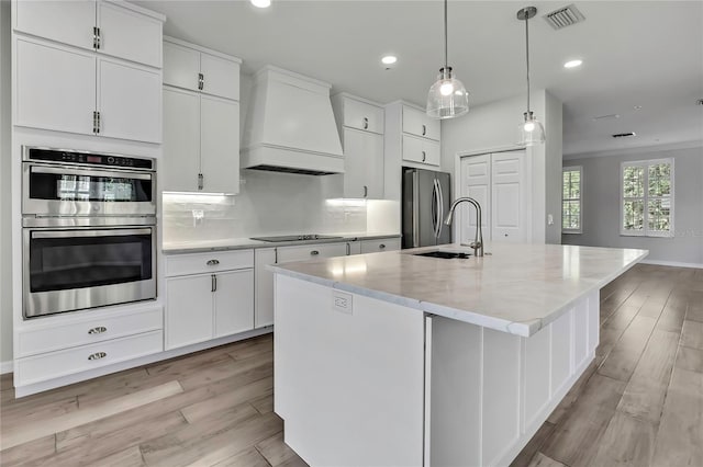 1402 Harbour Walk Rd, Tampa, FL 33602 - kitchen featuring appliances with stainless steel finishes, premium range hood, a sink, light wood-style flooring, and recessed lighting