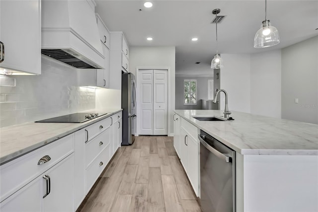 1402 Harbour Walk Rd, Tampa, FL 33602 - kitchen featuring a sink, appliances with stainless steel finishes, premium range hood, an island with sink, and light wood finished floors