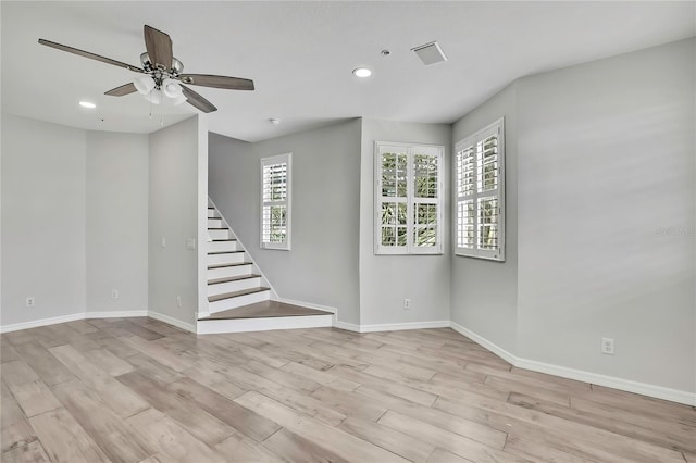 1402 Harbour Walk Rd, Tampa, FL 33602 - unfurnished room featuring stairs, baseboards, a ceiling fan, light wood finished floors, and recessed lighting