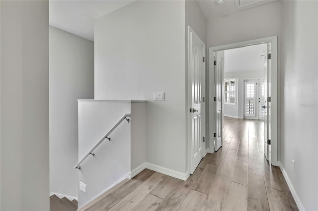 1402 Harbour Walk Rd, Tampa, FL 33602 - corridor featuring an upstairs landing, light wood-type flooring, and baseboards