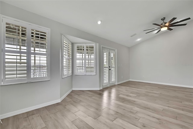 1402 Harbour Walk Rd, Tampa, FL 33602 - spare room with baseboards, wood finished floors, lofted ceiling, a ceiling fan, and french doors