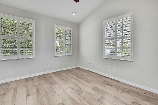 1402 Harbour Walk Rd, Tampa, FL 33602 - spare room with wood finished floors, baseboards, and lofted ceiling