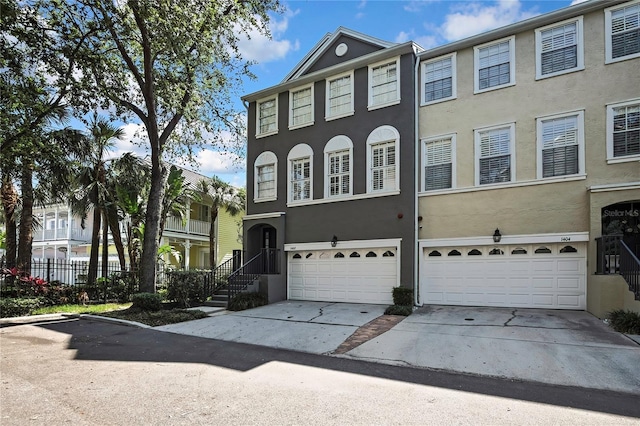 1402 Harbour Walk Rd, Tampa, FL 33602 - multi unit property featuring a garage, driveway, and stucco siding