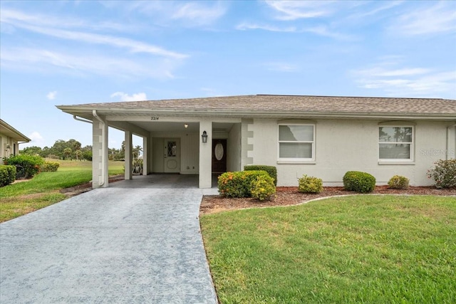 2214 Highclere Cir Unit 6, Sun City Center, FL 33573 - ranch-style home featuring driveway, a front yard, an attached carport, a shingled roof, and stucco siding