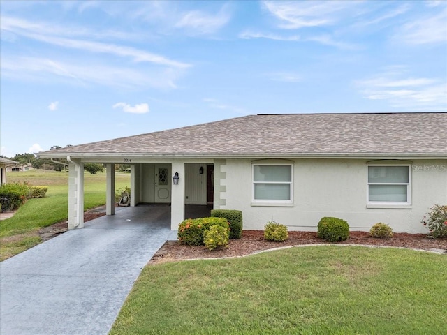 2214 Highclere Cir Unit 6, Sun City Center, FL 33573 - ranch-style house featuring driveway, a front yard, stucco siding, an attached carport, and a shingled roof