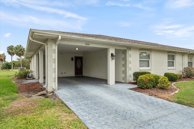 2214 Highclere Cir Unit 6, Sun City Center, FL 33573 - view of front of property with driveway, a carport, and a front lawn