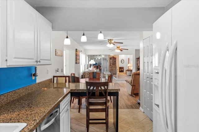 2214 Highclere Cir Unit 6, Sun City Center, FL 33573 - kitchen featuring white refrigerator with ice dispenser, a ceiling fan, stainless steel dishwasher, white cabinets, and light tile patterned flooring