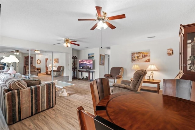 2214 Highclere Cir Unit 6, Sun City Center, FL 33573 - living room with a ceiling fan, light wood-type flooring, baseboards, and a textured ceiling