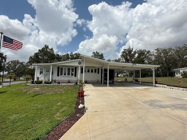 12021 Club House Rd, Brooksville, FL 34613 - view of front of house featuring a front yard, an attached carport, and driveway