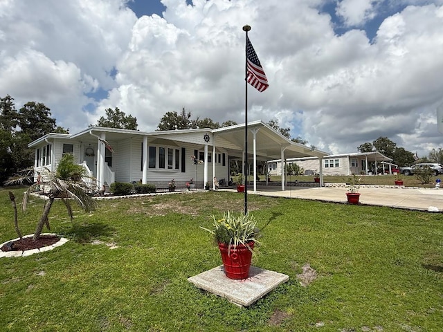 12021 Club House Rd, Brooksville, FL 34613 - manufactured / mobile home featuring a front lawn and a carport