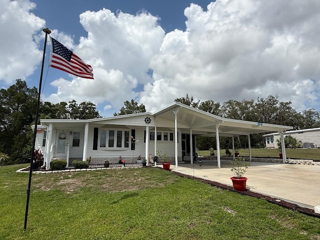 12021 Club House Rd, Brooksville, FL 34613 - view of front of house with a carport, a front yard, and driveway