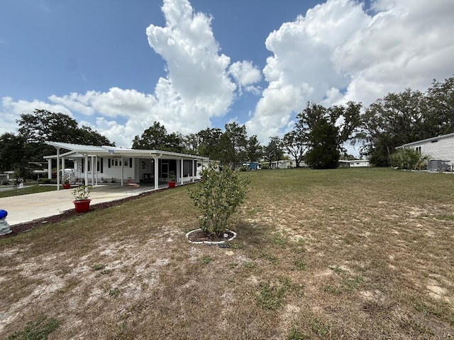 12021 Club House Rd, Brooksville, FL 34613 - view of grassy yard with a patio area and a carport
