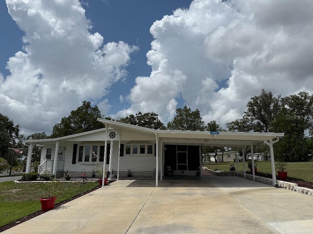 12021 Club House Rd, Brooksville, FL 34613 - view of front facade featuring driveway, a carport, and a front yard