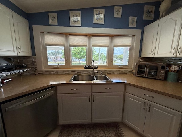 12021 Club House Rd, Brooksville, FL 34613 - kitchen with stainless steel dishwasher, a sink, tasteful backsplash, and white cabinets