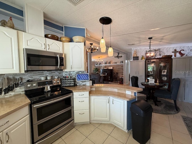 12021 Club House Rd, Brooksville, FL 34613 - kitchen with appliances with stainless steel finishes, light tile patterned floors, a peninsula, light countertops, and a textured ceiling