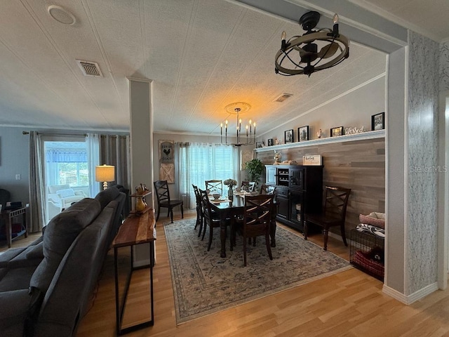 12021 Club House Rd, Brooksville, FL 34613 - dining space with a chandelier, light wood-type flooring, and crown molding