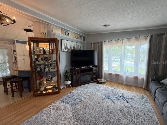 12021 Club House Rd, Brooksville, FL 34613 - living area with crown molding, wood finished floors, and a textured ceiling