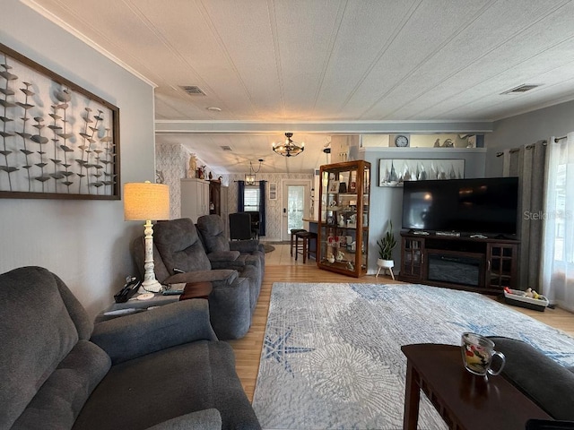 12021 Club House Rd, Brooksville, FL 34613 - living area featuring wood finished floors, a chandelier, and crown molding