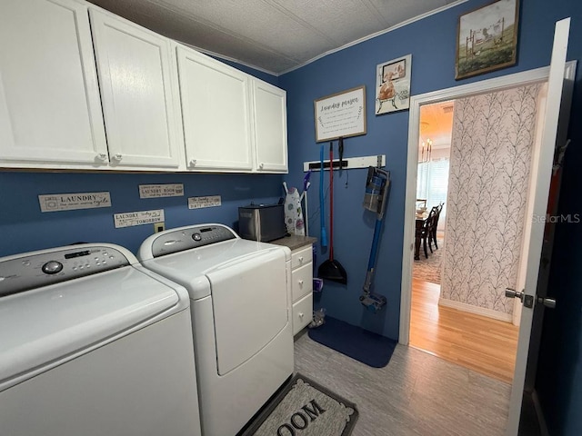 12021 Club House Rd, Brooksville, FL 34613 - laundry area with cabinet space, separate washer and dryer, light wood-style floors, and baseboards