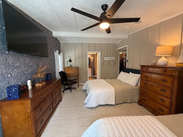 12021 Club House Rd, Brooksville, FL 34613 - bedroom with light carpet, ornamental molding, connected bathroom, ceiling fan, and a walk in closet