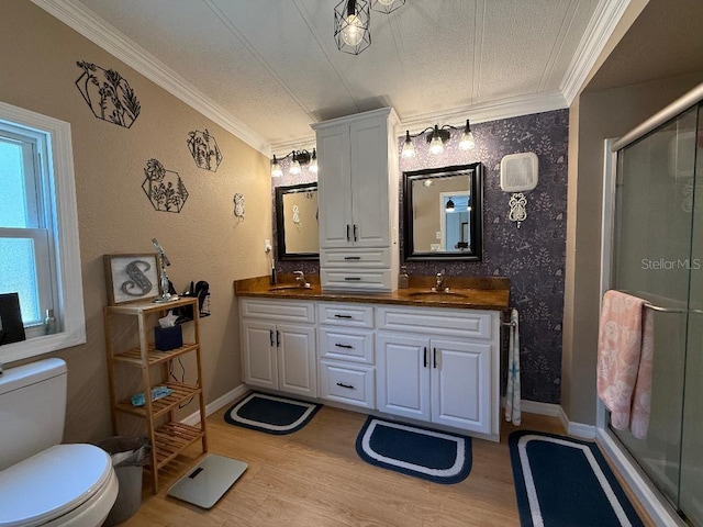 12021 Club House Rd, Brooksville, FL 34613 - bathroom featuring ornamental molding, double vanity, a stall shower, wood finished floors, and toilet