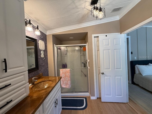 12021 Club House Rd, Brooksville, FL 34613 - ensuite bathroom featuring vanity, wood finished floors, a stall shower, and ornamental molding