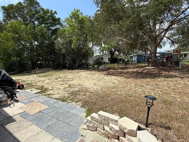 12021 Club House Rd, Brooksville, FL 34613 - view of yard featuring a patio