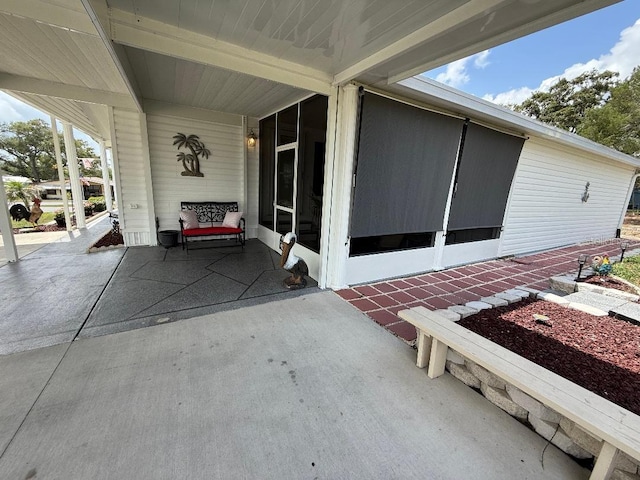12021 Club House Rd, Brooksville, FL 34613 - view of patio with a sunroom