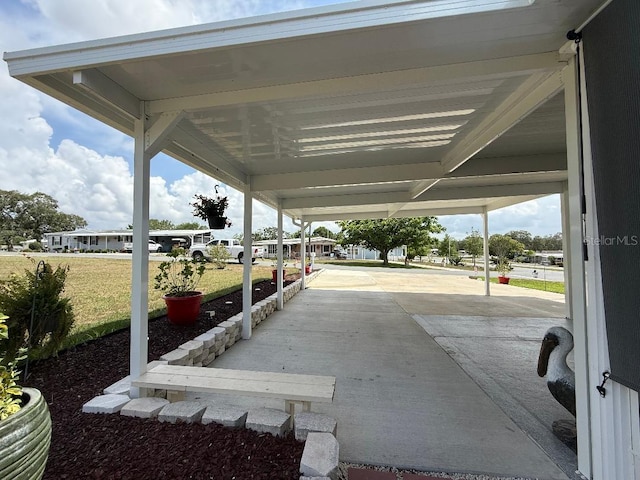 12021 Club House Rd, Brooksville, FL 34613 - view of patio / terrace featuring a carport and concrete driveway