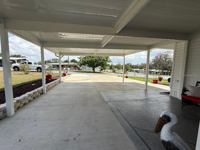 12021 Club House Rd, Brooksville, FL 34613 - view of patio with concrete driveway and a carport