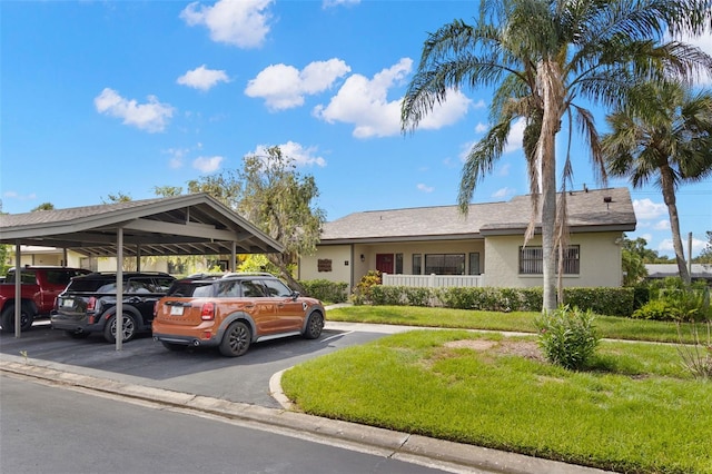 190 Dale Pl, Oldsmar, FL 34677 - ranch-style home with covered parking, stucco siding, and a front lawn