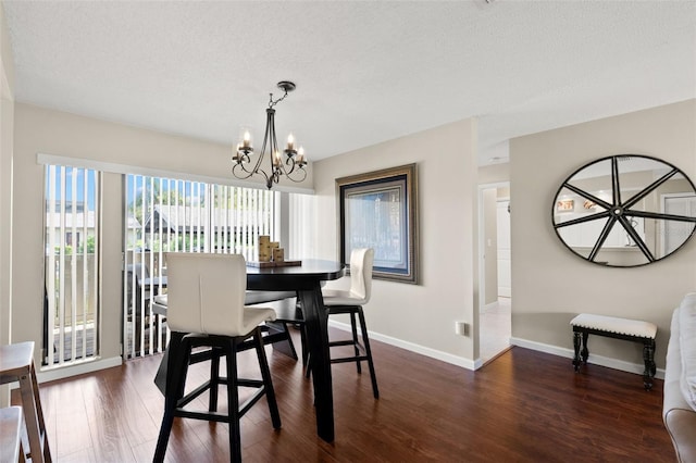 190 Dale Pl, Oldsmar, FL 34677 - dining room featuring a chandelier, dark wood-style flooring, and a textured ceiling
