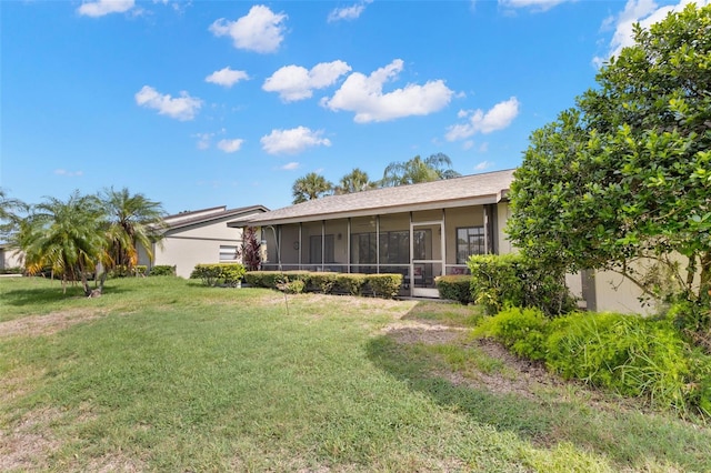 190 Dale Pl, Oldsmar, FL 34677 - rear view of house featuring a sunroom, a lawn, and stucco siding