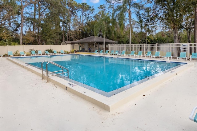 190 Dale Pl, Oldsmar, FL 34677 - community pool with view of wooded area and a patio