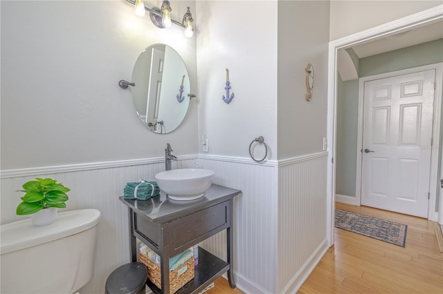 1807 Split Fork Dr, Oldsmar, FL 34677 - half bathroom with a wainscoted wall, wood finished floors, vanity, and toilet