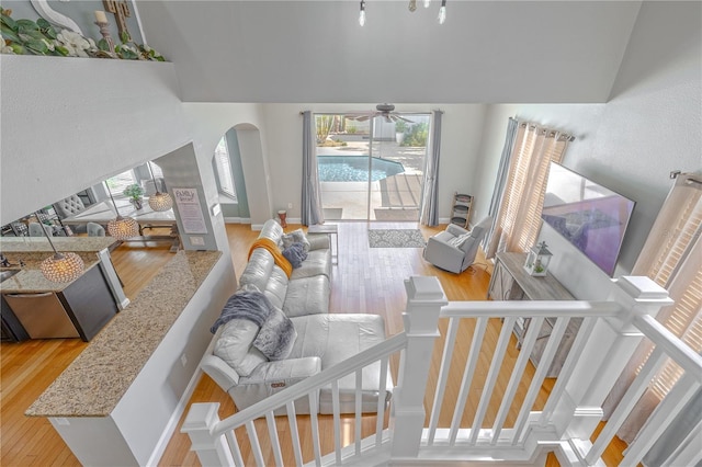 1807 Split Fork Dr, Oldsmar, FL 34677 - living area featuring plenty of natural light, hardwood / wood-style flooring, lofted ceiling, ceiling fan, and arched walkways