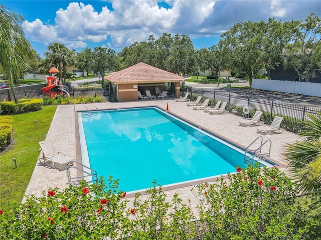 1807 Split Fork Dr, Oldsmar, FL 34677 - community pool with a patio area and view of wooded area