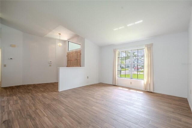 1838 Eagle Ridge Blvd, Palm Harbor, FL 34685 - unfurnished room with lofted ceiling and wood finished floors